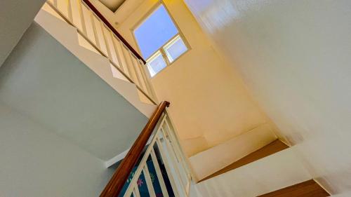a stairway with a window and a stair case at Caliraya Heights Resorts and Events Place in Halang