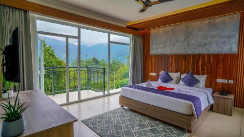 a bedroom with a bed and a balcony at Winter Note Resorts in Munnar