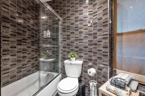 a bathroom with a toilet and a shower and a tub at Perfect Chic Apartment in Upper West of NYC! in New York