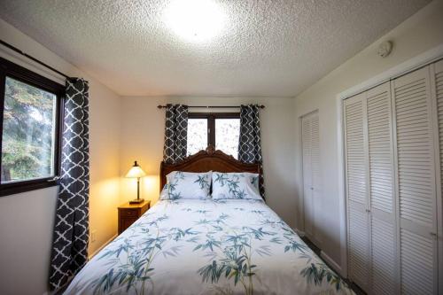 a bedroom with a bed and a window at Spenard Guest House - The Bamboo Room in Anchorage