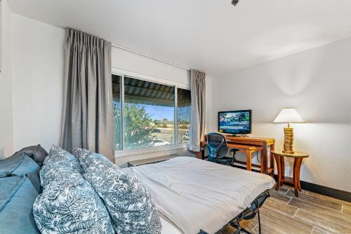 a bedroom with a bed and a desk and a window at Tempe Corner Apartment Studio King bed in Tempe