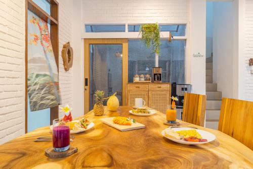 a dining room table with plates of food on it at 3Bedroom Private Pool Villa Casa De Nuri in Jimbaran