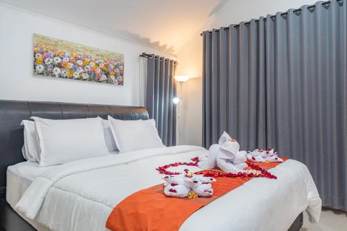 a bedroom with a bed with stuffed animals on it at 3Bedroom Private Pool Villa Casa De Nuri in Jimbaran