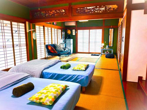 a bedroom with two beds and a living room at HS japan house in Ichiba