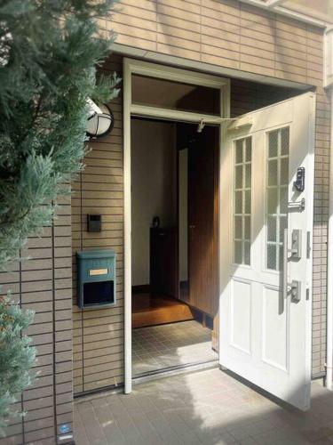 an open door of a house with a porch at M&Ks house in Tokyo