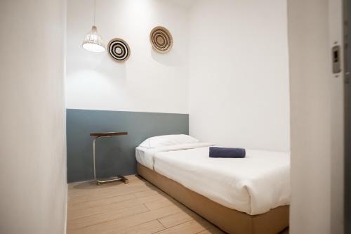 a bedroom with two beds and a wall at ITCC Manhattan Suites by Calvin in Donggongon