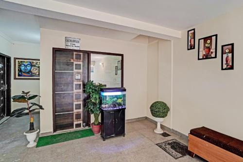 a living room with a fish tank in a room at Super OYO Golden Imperial Near PVR Ansal Plaza Greater Noida in Greater Noida