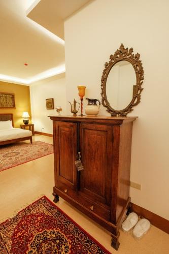 a mirror on top of a wooden cabinet in a room at Residencia Orlina in Dumaguete