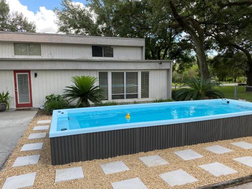 a swimming pool in front of a house at Reel relaxing across from River in Huge 24 foot Swim Spa in Tampa
