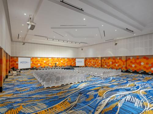 a large room with chairs and a large carpet at Aston Inn Tasikmalaya in Tasikmalaya