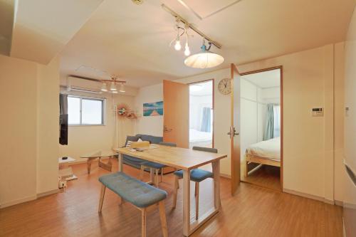 a dining room with a table and chairs and a bed at V.Close to Shinjuku Kabukicho/Korean Town/FrWIFI A in Tokyo