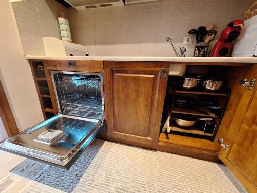 a kitchen with an open dishwasher in a kitchen at Cozy studio with balcony in 4-star hotel Saint Ivan Rilski, Bansko in Bansko
