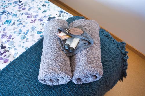 a towel is sitting on a bed with a roll at Kangarooby Cottage - A Peaceful Off-grid Escape 