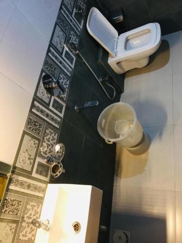 a bathroom with a toilet and a sink at Hotel KF Residency in Mumbai