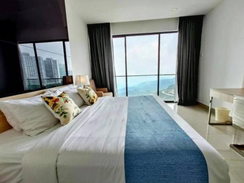 a bedroom with a large bed with large windows at GentingPeak8pax3BR110@IonDelemen in Genting Highlands