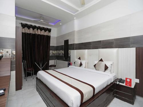 a bedroom with a large bed in a room at Collection O Hotel RV Palace in Agra