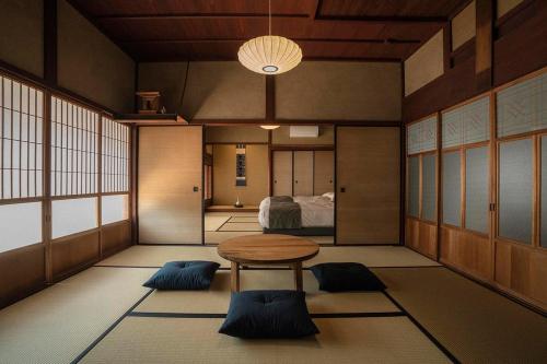 a room with a table and a bed in it at NIPPONIA平福宿場町 in Sayo
