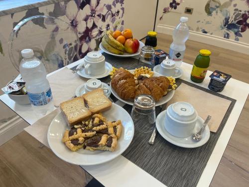a table topped with plates of food and drinks at B&B The Garden in Pescara