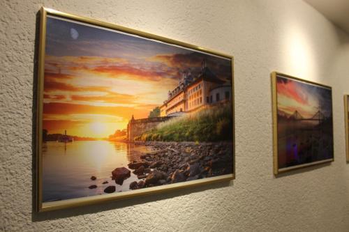 a painting of a sunset on a wall at Welcome-Home-Radeberg in Radeberg