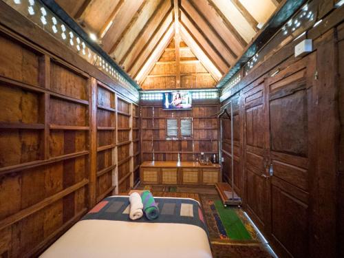 a small room with a bed and a tub in it at Kubu Kirana by Supala in Ubud
