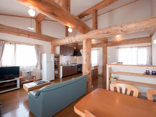 a kitchen and living room with wooden beams at Silver Birch in Niseko