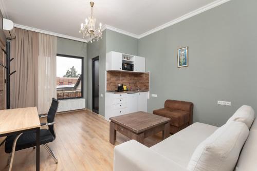 a living room with a couch and a table at Honeymoon Apartments in Old Tbilisi in Tbilisi City