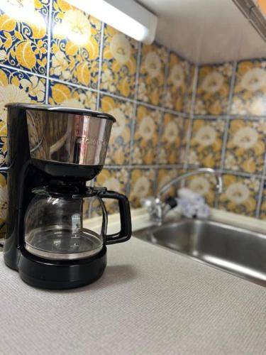 a blender sitting on a counter next to a sink at Apartment „Bergblick“ in Sankt Johann in Tirol