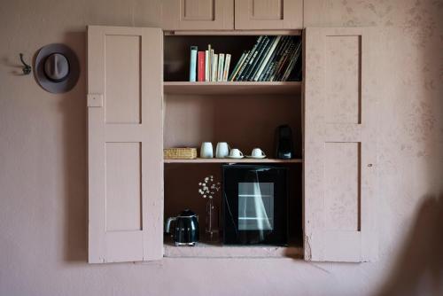 an open door to a book shelf with books at Vigne di Fagnano 1709 Eco Relais in Santo Stefano Belbo