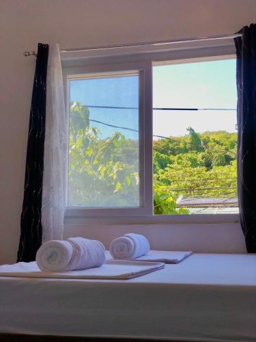 a room with a window with towels on a table at Chill Out Hostel in Boracay