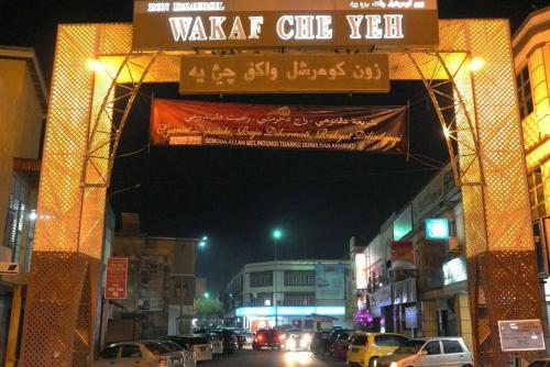 a street with cars parked on a city street at Homestay Abah Wakaf Che Yeh in Kota Bharu