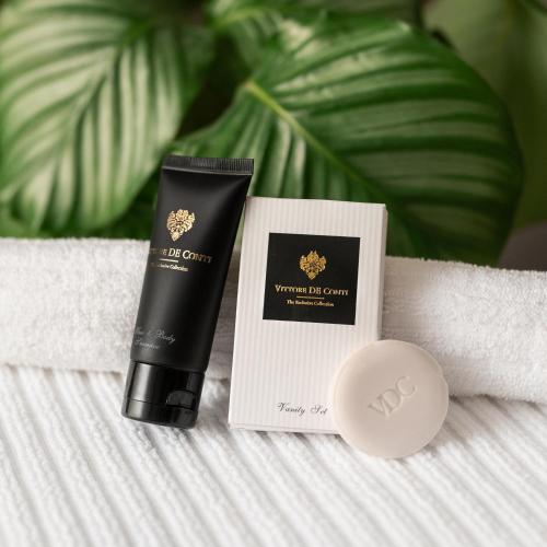 a bottle of moisturizing cream next to a tube of cosmetics at Piano apartments - LICITY in Žilina