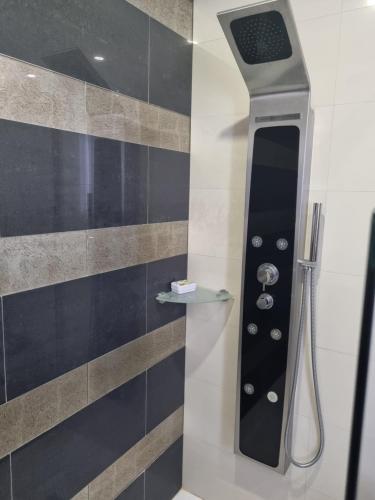 a shower with a shower head in a bathroom at My 2and house in Baleal