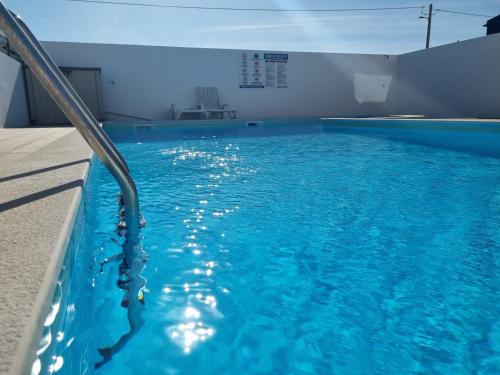 a swimming pool with blue water in a building at My 2and house in Baleal