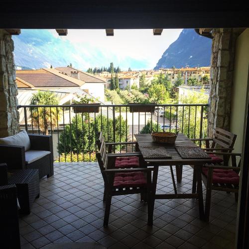 a patio with a table and chairs on a balcony at Dream of the Lake - Garda Village in Riva del Garda