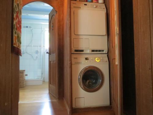 a washer and dryer in a small room at Bernerhof Residence in Grindelwald