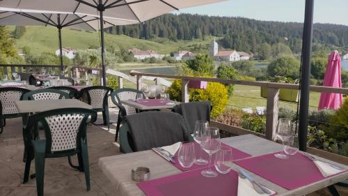 a restaurant with tables and chairs with a view at Hotel Lou Granva in Grande Riviere