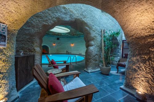 a room with a swimming pool in a house at Utopia Cave Cappadocia in Urgup