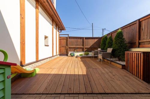 a balcony with a wooden floor and a building at Penzión Zemianska kúria in Dolný Kubín