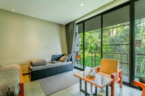 a living room with a couch and a table at K Mansion in Munnar