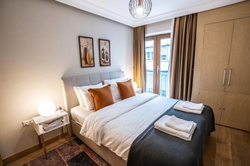 a bedroom with a large bed with orange pillows at Nianta 1-bedroom Near Osmanbey Metro in Istanbul