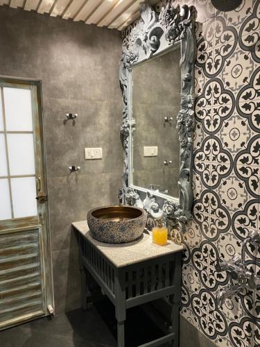 a bathroom with a sink and a mirror on a wall at S2 Beach Cottages in Morjim