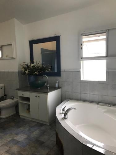 a bathroom with a tub and a sink and a toilet at La Caz in Bouchon