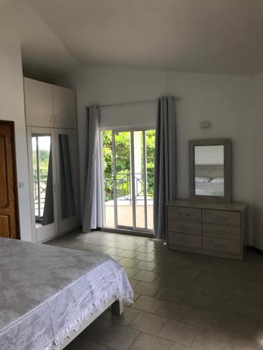 a bedroom with a bed and a dresser and a mirror at La Caz in Bouchon