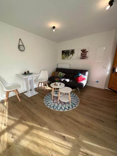 a living room with a couch and a table at Villa Waldulm in Kappelrodeck