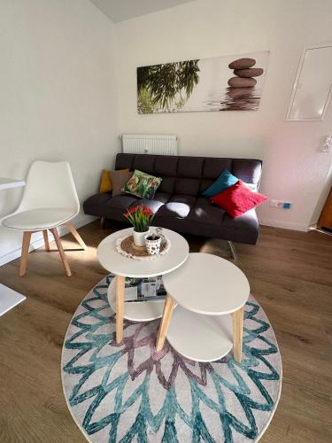 uma sala de estar com um sofá e duas mesas em Villa Waldulm em Kappelrodeck