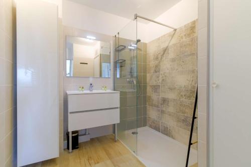 a bathroom with a sink and a shower at SELECT'soHOME - Appartement face à la mer avec piscine à Bormes-les-mimosas - CAPNAT-C04 in Bormes-les-Mimosas
