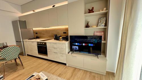 a kitchen with a large flat screen tv in a room at Jack, 2 people, renovated stylish apartment in Athens