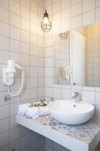 a white bathroom with a sink and a mirror at Enalia Villas in Ierissos