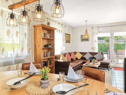 a living room with a table and a couch at Haus Sonneneck in Kaltenhof