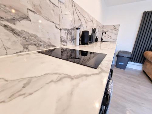 a marble counter top in a kitchen with a sink at Kaoglen Buck Pod - Hot Tub - Feature - Pets in Blairgowrie